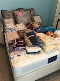 Like new full size mattress and boxspring/frame. Lot of high quality linens and  pillows