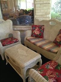 White wicker settee with matching chairs and table