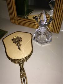 Vintage hand mirror and perfume bottle
