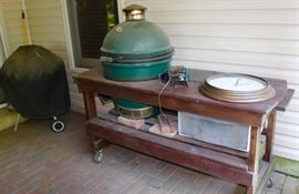 This is the Big Green Egg, in it's own prep table. It needs to be cleaned, but people rave about this grill. in the background is a Weber charcoal grill.