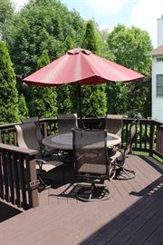 Patio table with four chairs and umbrella.