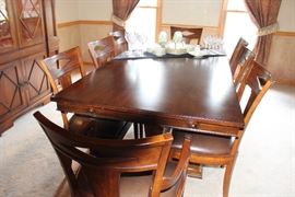 Bernhardt Dining set. Has two leaves that fit on either end, rather than the middle opening. The chairs (10) are fabulous with leather seating. This is one dynamite dining set. Check out the china cabinet, too.