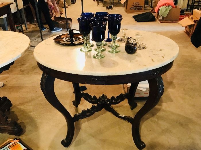 Another  carved stretcher table with marble top