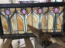 Large assortment of stained glass windows and panels