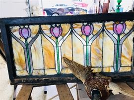 Large assortment of stained glass windows and panels