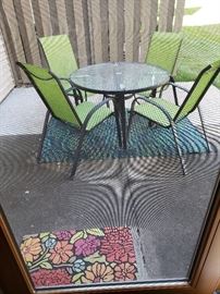 OUtdoor table and chairs in fun green color!  Outdoor carpet underneath table; colorful doormat!