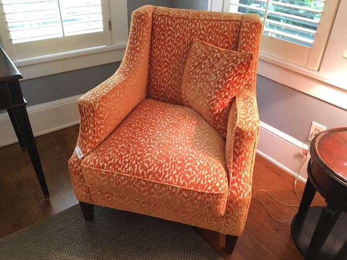 Arm chair upholstered in orange velvet with tan accents