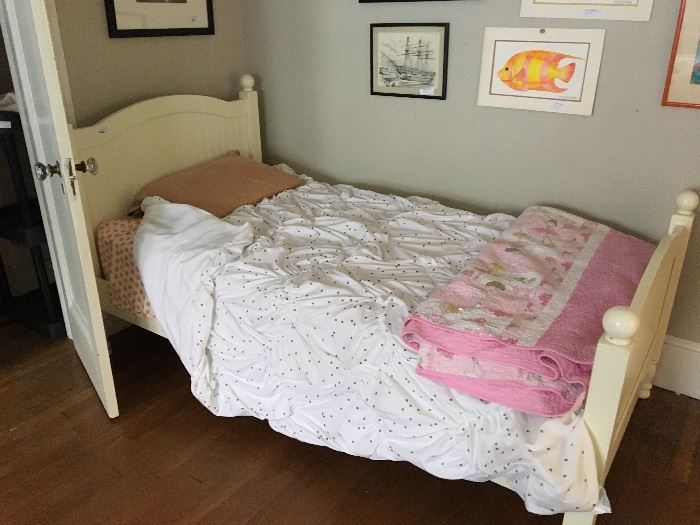 Twin bed with bedding and mattress