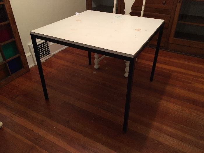 Knoll Mid-Century Modern "T Angle" dining table in white laminate and black enameled steel by Florence Knoll , Knoll Associates. Has sticker on bottom of table. Measures 28" high, 34" x 34". Base is in good condition, but the laminate top has some marks.