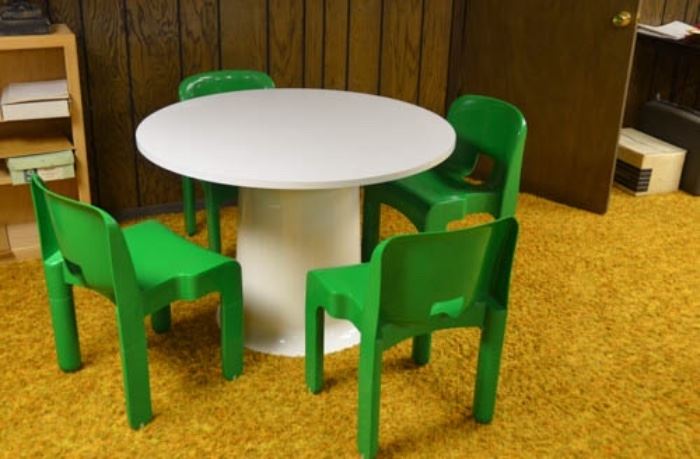 Vintage Kartell white round table with solid, sturdy green plastic chairs.  Standard height table and adult size chairs, even though it all looks smaller.