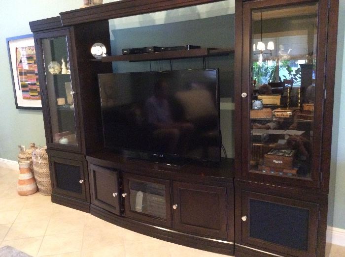 Broyhill dark mahogany media center with lighted glass side cabinets. Measures 108"L x 76"H x 20"D. TV not for sale