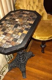 Fabulous antique games table featuring individual hand cut squares of different varieties of marble and a heavily detailed hand carved wooden base 