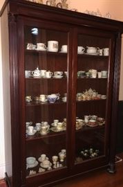An empire bookcase with glass doors here used to house a cup and saucer collection spanning 150 years. 