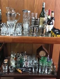 Geat collection of barware accessories on a Mid Century bar cart. Atomic martini set, Old Crow glasses, glass swizel sticks, jigger set, so much more. 