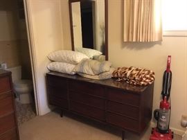 Another beautiful mid-century modern dresser with mirror, pillows, throws.