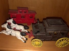 Cast Iron stagecoach pulled by horses, cabboose