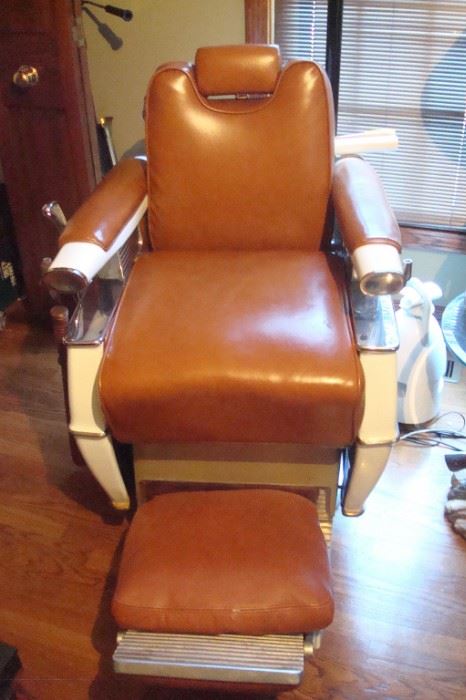 Antique barber chair with leather surfaces in excellent condition.