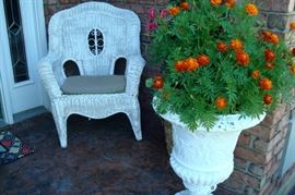 Pair of of wicker chairs and pair of large planters.