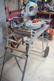 Makita compound miter saw on movable base.