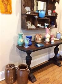 Sofa table could have a million uses .... Look at the crock churns (one with top) AND all of the collectible pottery!