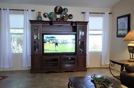 Expandable entertainment center. Fits a smaller TV or Expands to fit an 80 inch TV. 55" TV for sale too and another nice smaller one. Samsung sound bar.