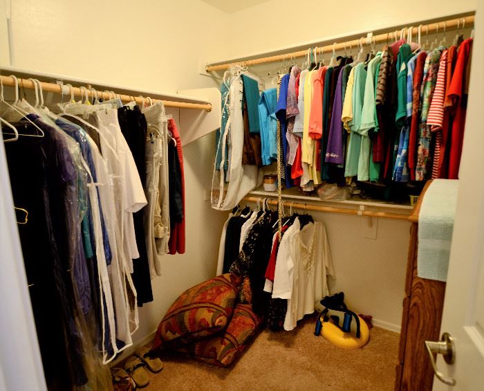 Very nice women's clothing, pillows, and another dresser.