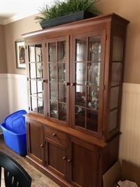 China cabinet by Ethan Allen full of crystal and glassware.