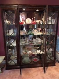Curio cabinet loaded with crystal and smalls. 