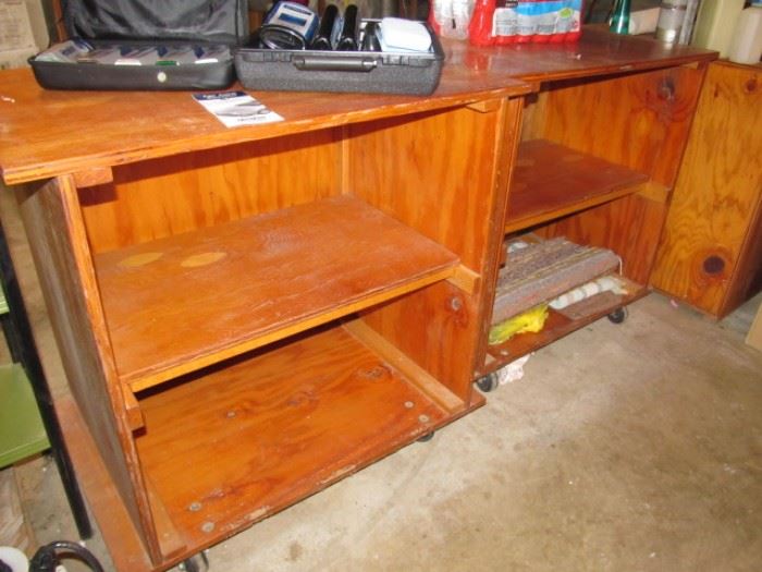 Several plywood work cabinets on wheels-there is a large top that can span these for a large work surface