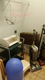 2 vacuum cleaners, metal kitchen cart, metal bread box-needs some repair, vintage TV trays, pink lingerie drying rack, metal hanging basket. 