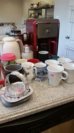 Bella coffee maker in red with instructions, 2 thermal coffee carafes, Mr. Coffee whole bean grinder, & misc. coffee cups.