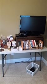 Vintage swivel TV stand, Vizio TV/DVD player, wooden desktop adjustable bookcase. 