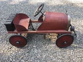 This is an extremely rare American National Pedal Car. It has a wood frame and pressed steel. It has the original Dash, simulated parking brake, oil can etc. The seat is loose. This is an amazing piece of Pedal Car History. Fully restored version sell for upwards of $10K. Thinks can be yours for $ 4995 (Firm)