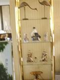Brass/glass display shelf in living room with Royal Copenhagen and Lladro pieces