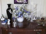 Collectibles in dining room.  Lucite candlestick, glass floral arrangement.