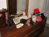 Purses and hats including a mesh evening bag by Whiting & Davis.