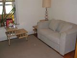 Pair matching blonde veneer end tables, midcentury lamp, Lenox teapot and nearly new loveseat pulls out to twin bed.