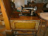 Antique Singer sewing machine in cabinet