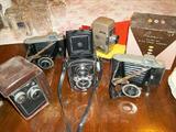 Vintage cameras including 2 Yashica COPAL-MXV (1957), 2 Kodak Tourist Cameras (1948-51) and a Revere Model 80 8mm Spool Camera in original box.