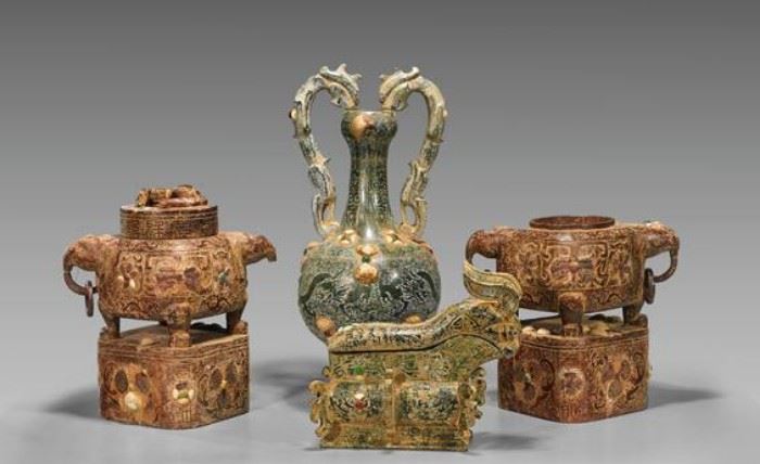 Four carved stone and inlaid shell vessels: pair of round censers atop a plinth, one with cover; gong together with amphora vase with double handles; H: 22″ (tallest)