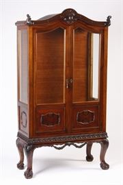 Wooden display cabinet with glass on three sides for maximum viewing. 