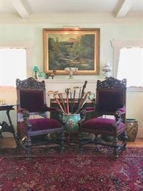 Skillfully Carved Hall-Chairs w/Lion Heads, Turned Legs and Pierced Grape Motif Crest, flank the stately fireplace