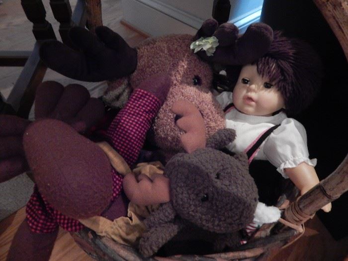 Vintage stuffed animals and one doll.