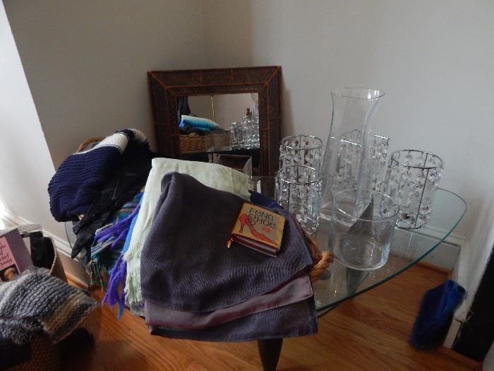 Many winter scarves, glass candle containers.