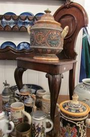 The pot on the chair is a German Punch Bowl  inscribed in German "May your life always be blessed with heath, luck & contentment" Other side says "Who does not love, drink, and sing, will never achieve true happiness" We also have beautiful steins.