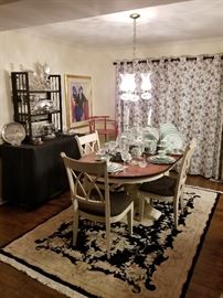 Overview of dining room with hand knotted rug
