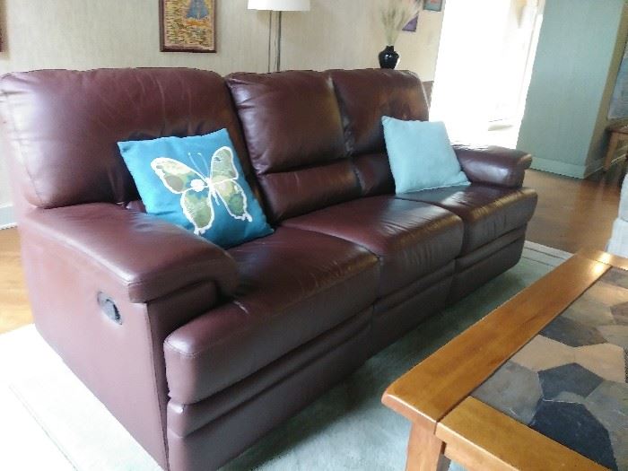 Leather sofa with side reclining feature