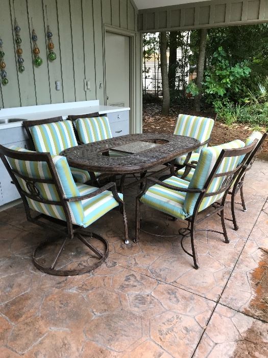 Patio dining table with six chairs. 2 chairs swivel. 