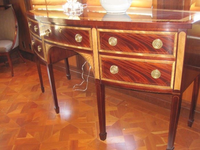 Mahogany Bow front Sideboard with double banded inlays and maple fan fronts on spade feet by Baker.