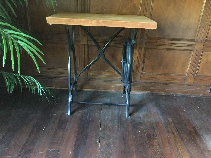 Antique sewing machine base with chopping block top.